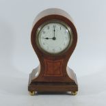 An Edwardian walnut balloon shaped mantel clock,