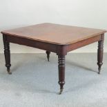 A Victorian mahogany dining table, on turned legs,