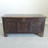 An 18th century oak and inlaid coffer, on stile feet,