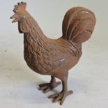 A rusted cast iron model of a hen,