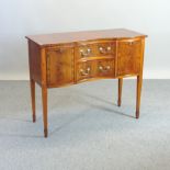 A reproduction yew wood serpentine sideboard, 107cm,
