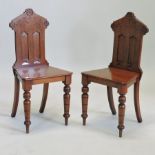 A pair of Victorian walnut hall chairs