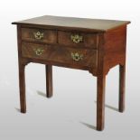 An 18th century style walnut and crossbanded lowboy, the quarter veneered top with feather banding,