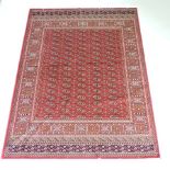 A Bokhara style rug, with all over medallions, on a red ground,
