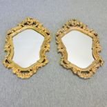 A pair of gilt framed Rococo style wall mirrors