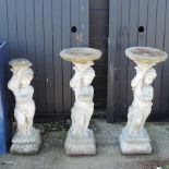 Three reconstituted stone cherub bird baths,