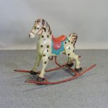 A vintage painted tin children's rocking horse,