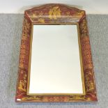 A red toleware style chinoiserie painted metal wall mirror,