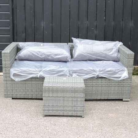 A grey rattan sofa, with loose cushions, 173cm,