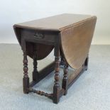 An oak gateleg table, on turned legs,