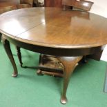 An early 20th century Waring and Gillows mahogany dining table,