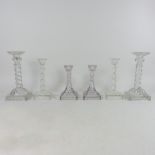 A collection of glass candlesticks,