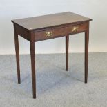 An early 20th century oak side table, with a single drawer and stylised handles,