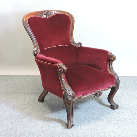 A 19th century walnut and red upholstered spoon back armchair