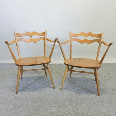 A pair of Ercol light elm cowhorn shaped side chairs