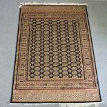 A Bokhara style rug, with all over medallions, on a blue ground,