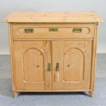 An antique pine side cabinet,
