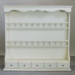 A white painted plate rack,