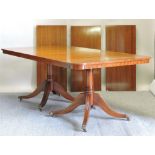 A Regency style mahogany extending twin pillar dining table, with three additional leaves,