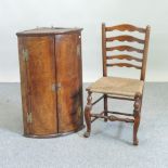 A George III oak bow front hanging corner cabinet, 60cm wide,