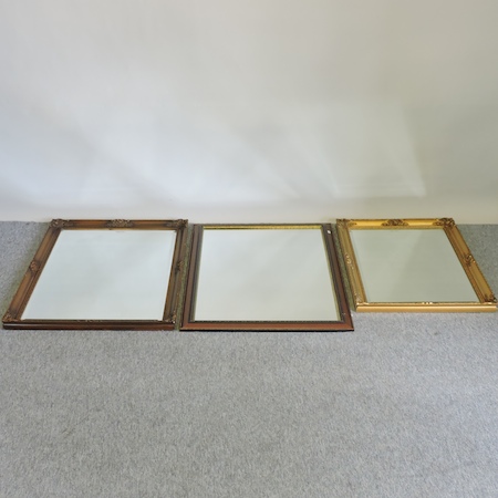 A collection of three wall mirrors,