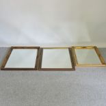 A collection of three wall mirrors,