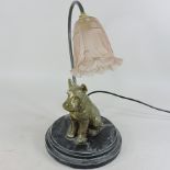 A table lamp, in the form of a dog, with a pink glass shade,