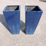 A set of two large blue painted garden pots,