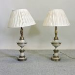 A pair of gilt and cream painted table lamps and shades,