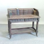 A Victorian heavily carved oak desk, on bobbin turned legs, 108cm,