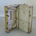 A vintage travel wardrobe, with a fitted interior,