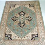 A Heriz style rug, with a central medallion, on a green ground,