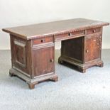 An early 20th century adapted walnut pedestal desk,