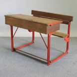 A pine and red painted metal school desk,