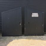 A pair of black painted wooden driveway gates,