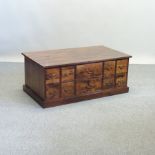 A hardwood coffee table, fitted with ten drawers,