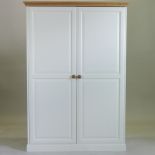 A modern pine and painted wardrobe,