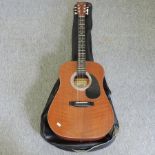 A Hondo II acoustic guitar,