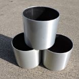 A set of three brushed aluminium painted garden pots,