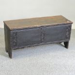 An 18th century oak six plank coffer, with a hinged lid,