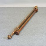 A wooden curtain pole, together with another similar,