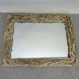 An Oka driftwood framed wall mirror,