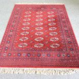 A Bokhara woollen rug, on a red ground,