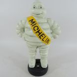 A painted metal model of the Michelin man,