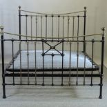 A Victorian style black painted metal and brass bedstead, with a folding sprung base,