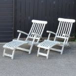 A pair of teak garden steamer chairs