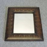 An oyster laburnum framed wall mirror,