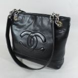 A Chanel style lades black leather handbag,