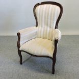 A Victorian style cream striped upholstered armchair