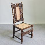 A 19th century carved oak hall chair with a cane seat